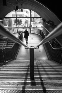A black and white image of a figure on a staircase